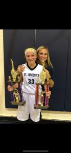 Mother and daughter hugging with two trophies