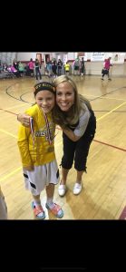 Mother and daughter hugging with a medal