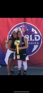Mother and daughter hugging with a trophy