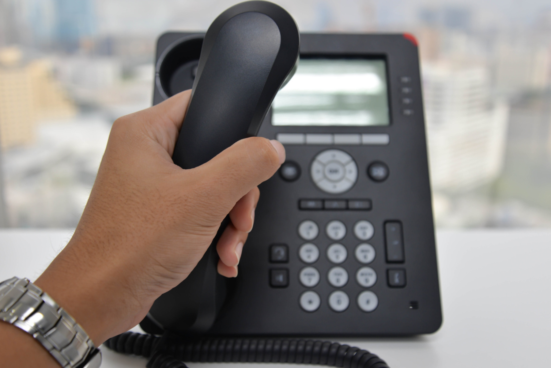 Someone answering an office phone.
